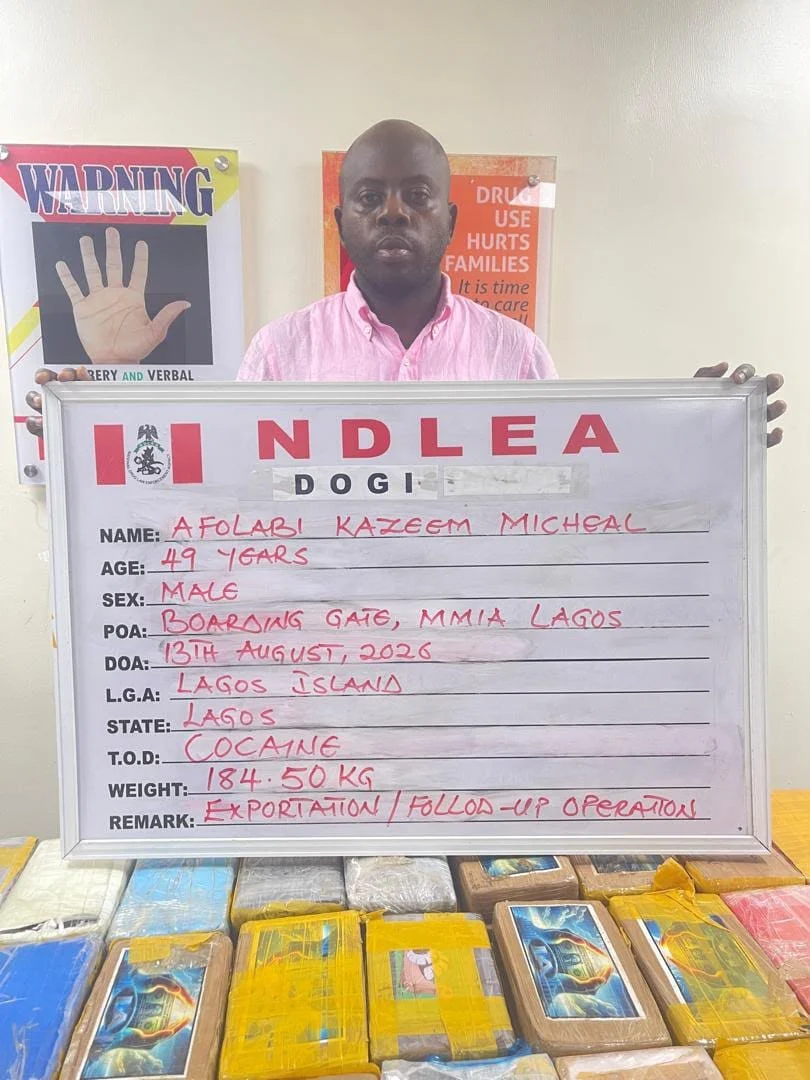 NDLEA officials display seized cocaine during an operation against an alleged international drug trafficking cartel in Nigeria.